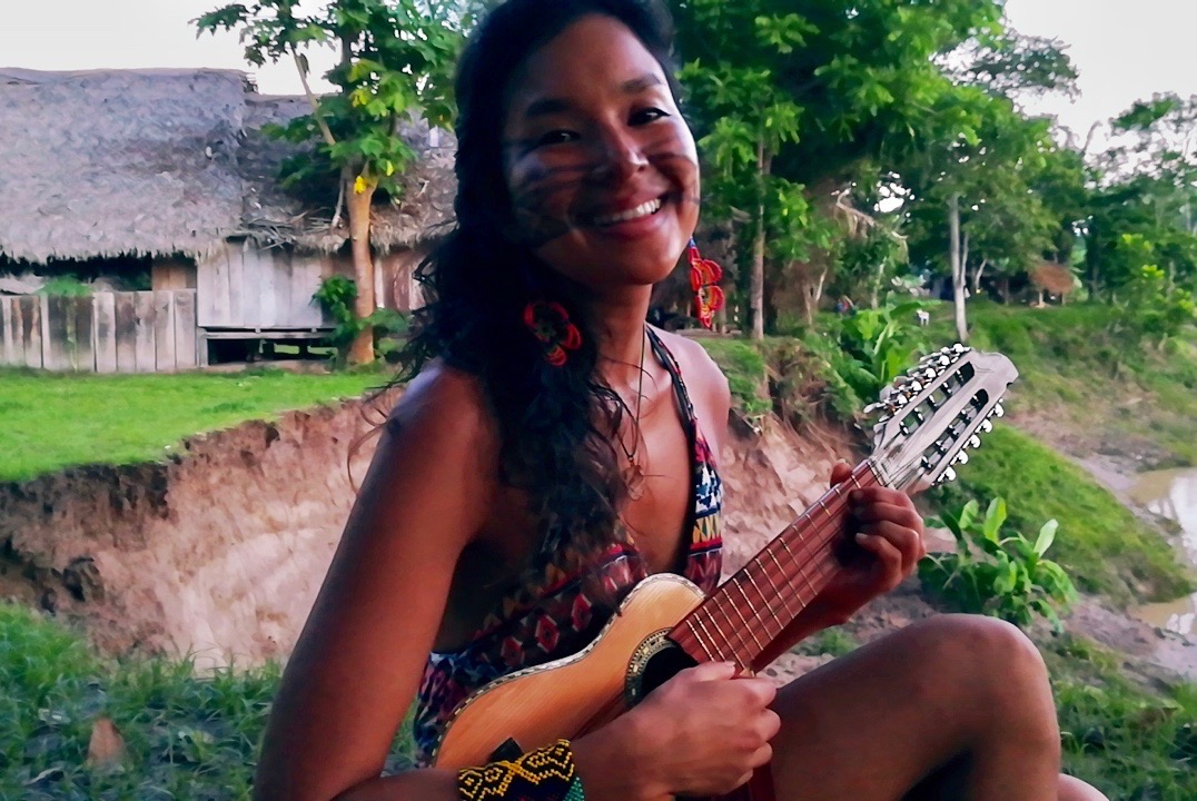 Learning new songs at Novo Futuro village.