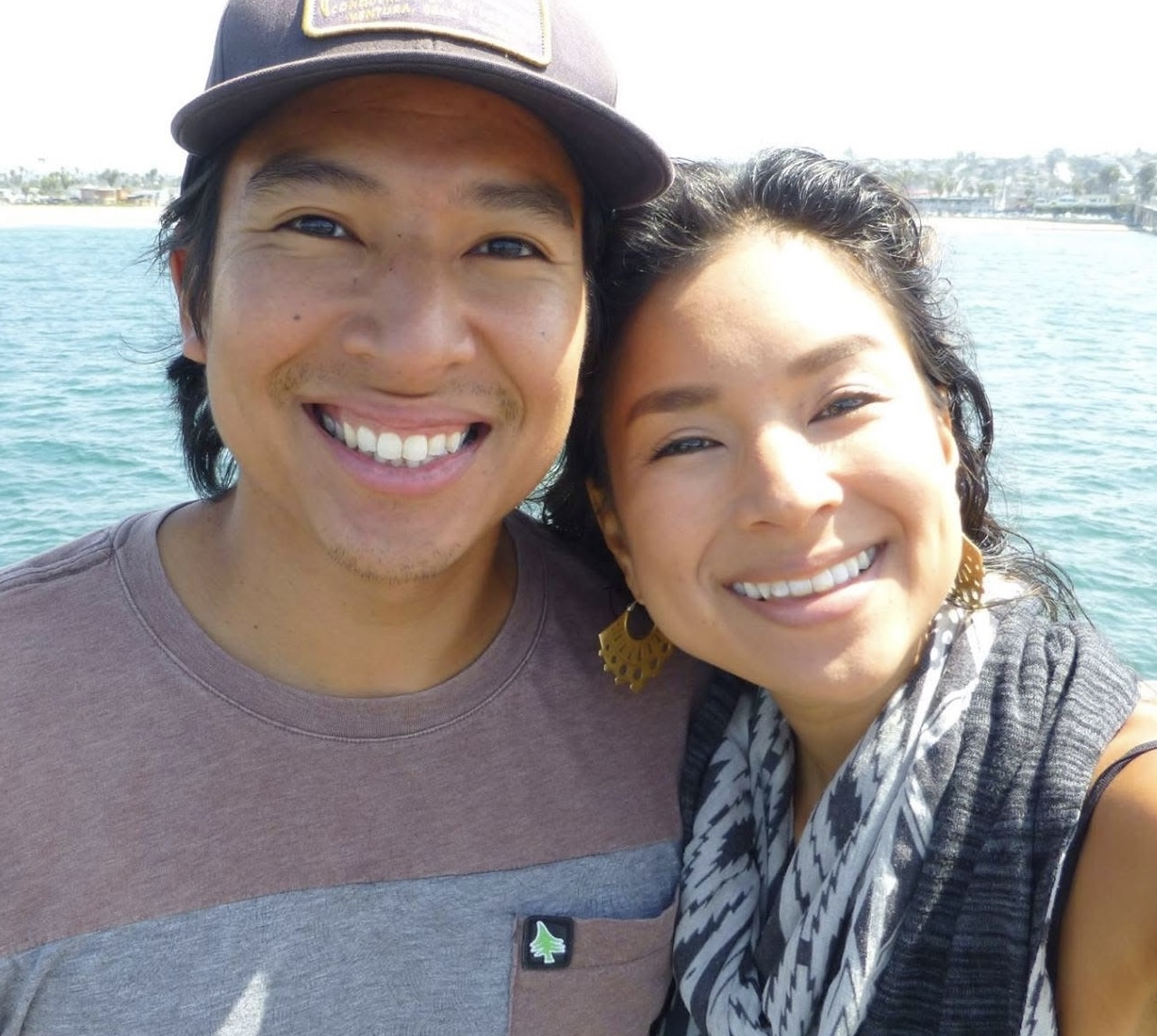 Aimi and her brother Paul smiling together by the water